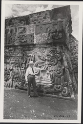 Edgar Hewett leaning against ruins in Xochicalco, Mexico