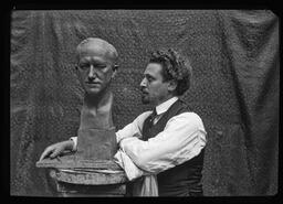 Artist Salvatore Scarpitta with his bronze bust of Edgar L. Hewett