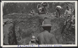 A group sketching the excavated rooms at an archaeological dig site during southwest summer school, Jemez, New Mexico